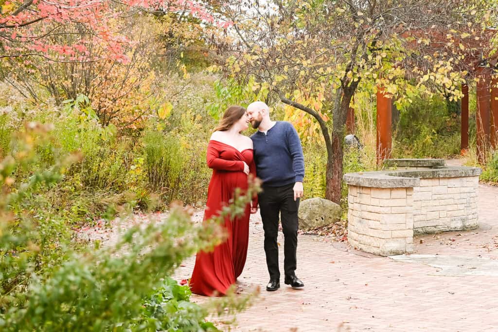 Couple embraces in colorful autumn garden